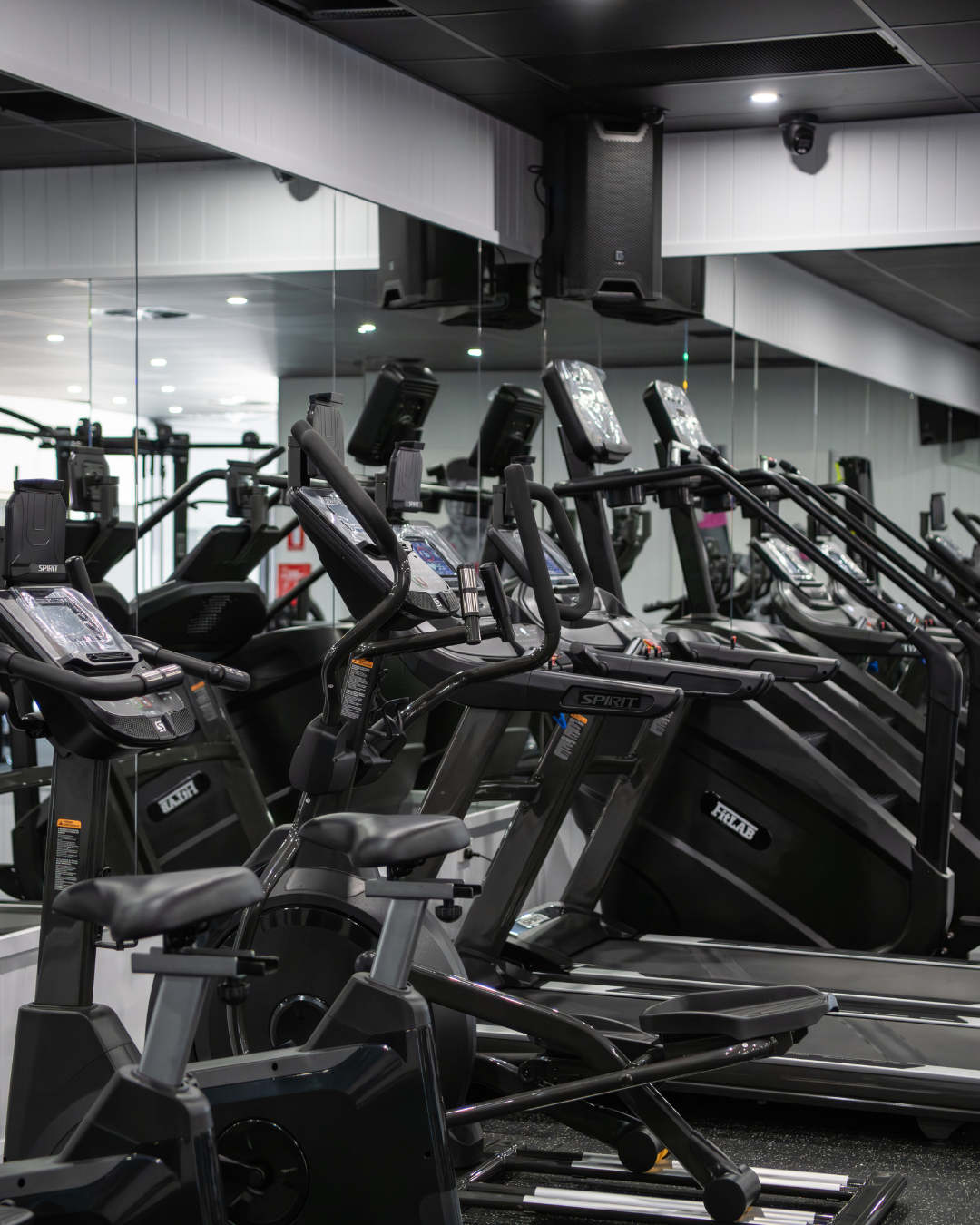 Row of exercise bikes in a gym with visible Fitlab branding.